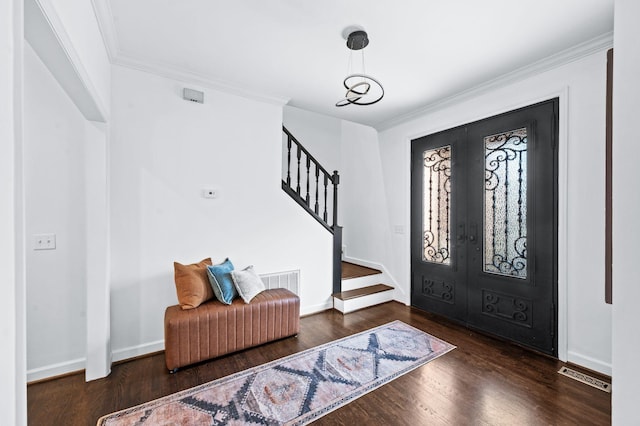 foyer entrance featuring french doors, stairs, wood finished floors, and visible vents