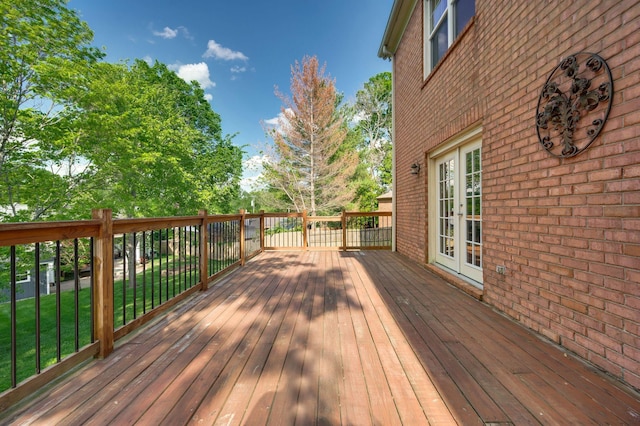deck with french doors and a yard