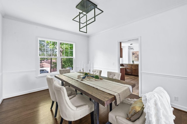 dining area featuring crown molding, baseboards, and dark wood-style floors