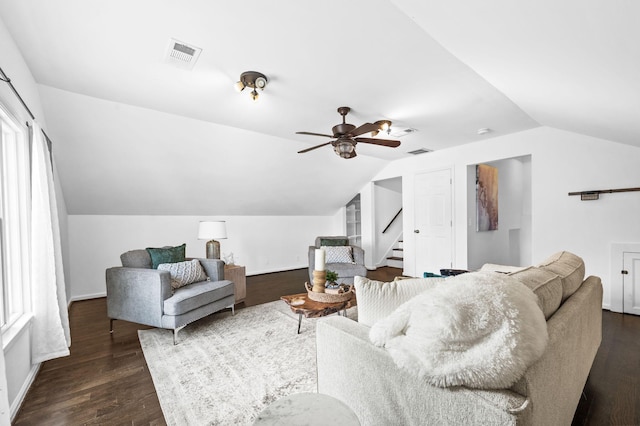 living area featuring stairway, a ceiling fan, lofted ceiling, and visible vents