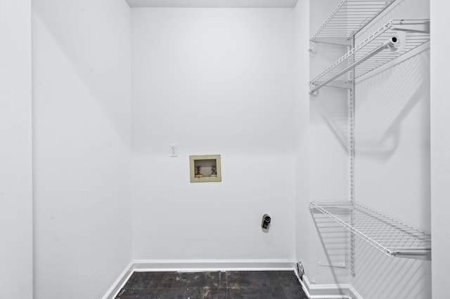 clothes washing area featuring baseboards, laundry area, hookup for a washing machine, and wood finished floors