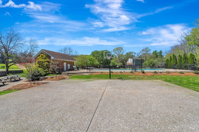exterior space with fence, a swimming pool, and a patio area