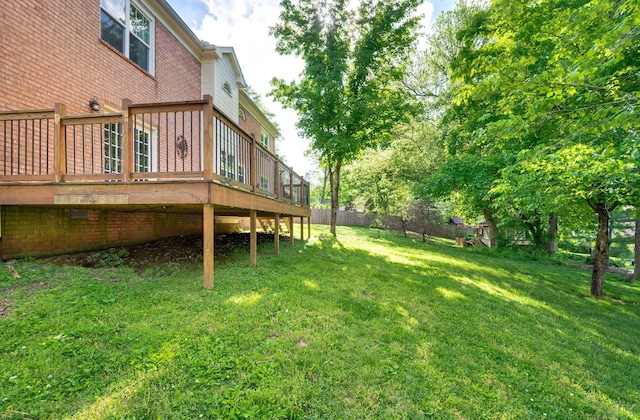 view of yard featuring fence and a wooden deck