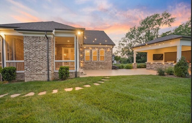 8119 Schweitzer Pl, Arrington, TN 37014 - rear view of house featuring brick siding, a patio area, and a lawn