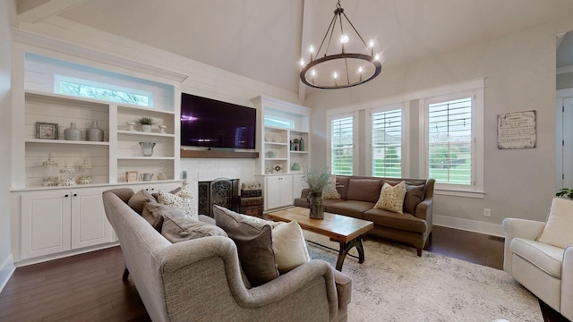 8119 Schweitzer Pl, Arrington, TN 37014 - living room with a healthy amount of sunlight, baseboards, dark wood finished floors, and a notable chandelier