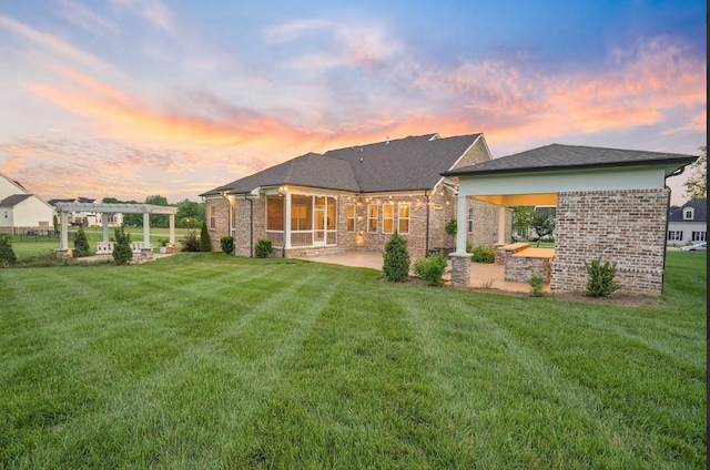8119 Schweitzer Pl, Arrington, TN 37014 - back of property at dusk with brick siding, a patio area, a yard, and a pergola