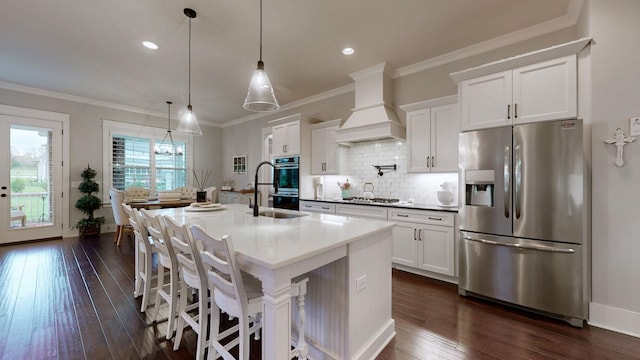 8119 Schweitzer Pl, Arrington, TN 37014 - kitchen featuring dark wood-style flooring, a center island with sink, white cabinets, tasteful backsplash, and stainless steel appliances