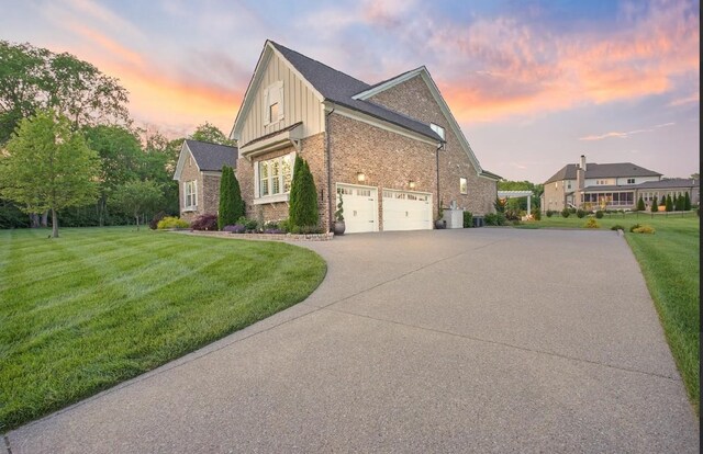 8119 Schweitzer Pl, Arrington, TN 37014 - view of side of property featuring board and batten siding, a lawn, a garage, brick siding, and concrete driveway