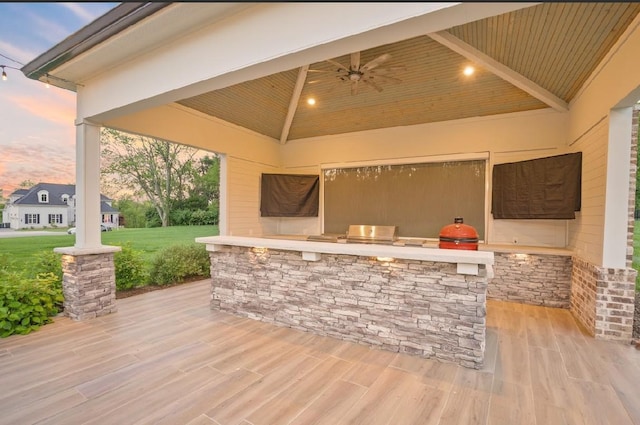 8119 Schweitzer Pl, Arrington, TN 37014 - patio terrace at dusk featuring a yard, exterior kitchen, a gazebo, and a ceiling fan