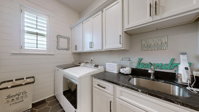 8119 Schweitzer Pl, Arrington, TN 37014 - laundry room featuring wood walls, washer and dryer, dark tile patterned floors, a sink, and cabinet space