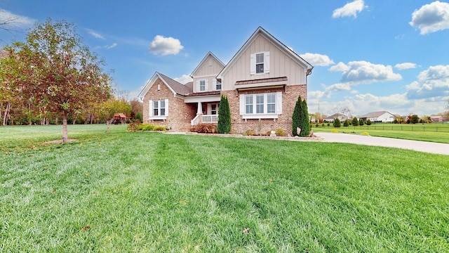 8119 Schweitzer Pl, Arrington, TN 37014 - craftsman-style house featuring brick siding, board and batten siding, covered porch, and a front yard