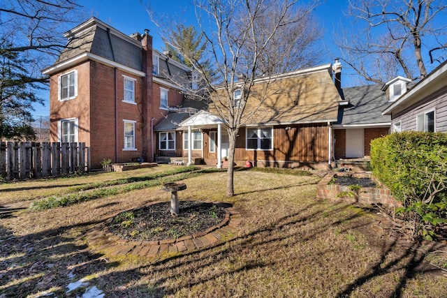 207 Dunlap St, Paris, TN 38242 - back of house with brick siding, a lawn, fence, and a chimney