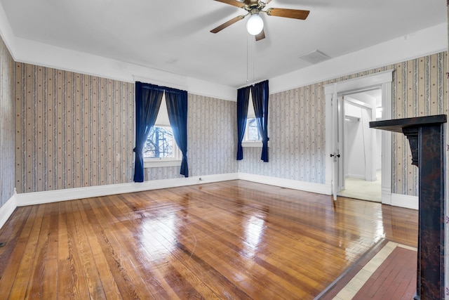 207 Dunlap St, Paris, TN 38242 - interior space featuring wood-type flooring, a ceiling fan, visible vents, and wallpapered walls