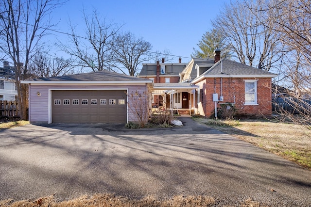 207 Dunlap St, Paris, TN 38242 - view of front facade with a porch, a chimney, fence, and brick siding