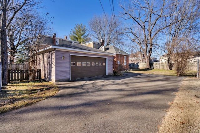 207 Dunlap St, Paris, TN 38242 - view of side of property featuring fence, a chimney, and a garage