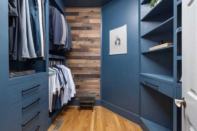 walk in closet with wood finished floors and visible vents