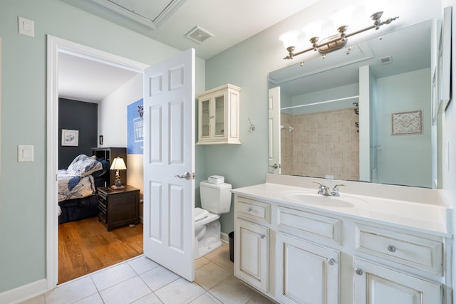 bathroom featuring visible vents, tile patterned floors, toilet, and vanity