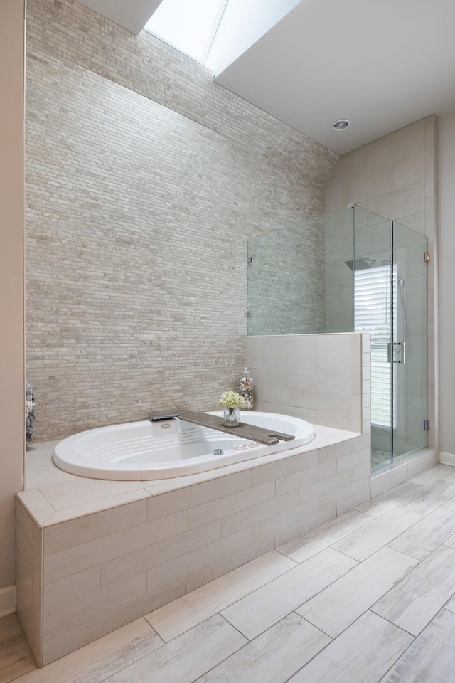 bathroom featuring a bath and a stall shower