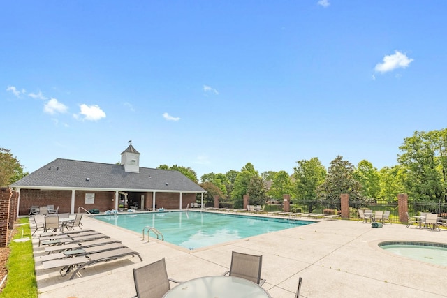 community pool featuring a patio area and fence