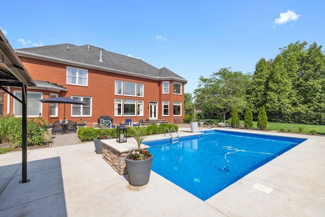 outdoor pool with a patio area