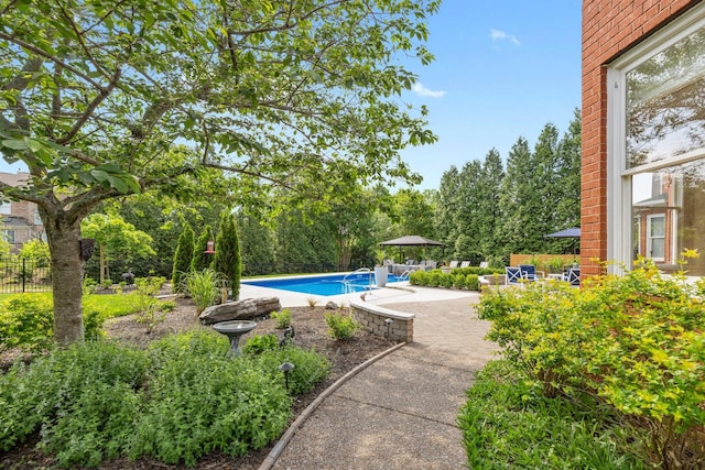 outdoor pool with a patio and fence