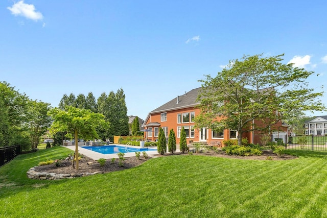 view of pool with a lawn, fence, and a fenced in pool