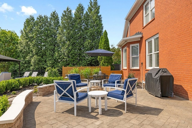 view of patio featuring area for grilling and fence