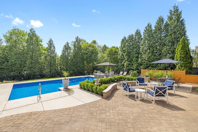 view of swimming pool featuring a fenced in pool, fence, and a patio