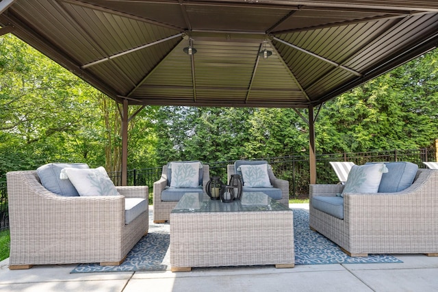 view of patio featuring a gazebo, outdoor lounge area, and fence