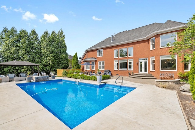 view of swimming pool with a patio, an outdoor hangout area, french doors, and a fenced in pool