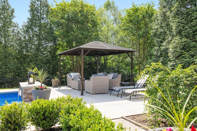 view of patio with a fenced in pool, fence, a gazebo, and outdoor lounge area