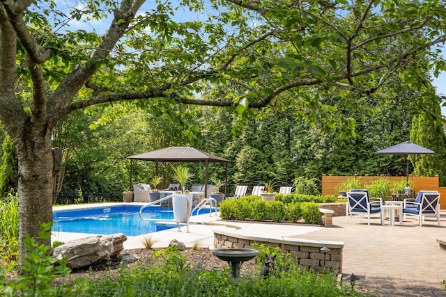 view of swimming pool featuring a fenced in pool, fence, a gazebo, and a patio area