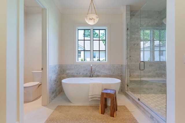 111 Keyway Dr, Nashville, TN 37205 - bathroom with a stall shower, a freestanding tub, tile walls, a wainscoted wall, and toilet