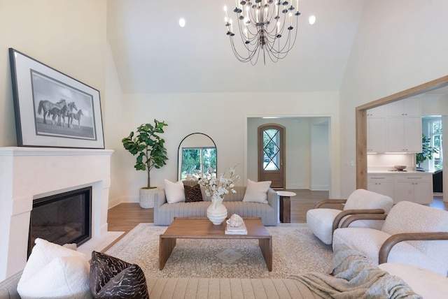111 Keyway Dr, Nashville, TN 37205 - living area with high vaulted ceiling, a chandelier, light wood-type flooring, a fireplace with flush hearth, and baseboards