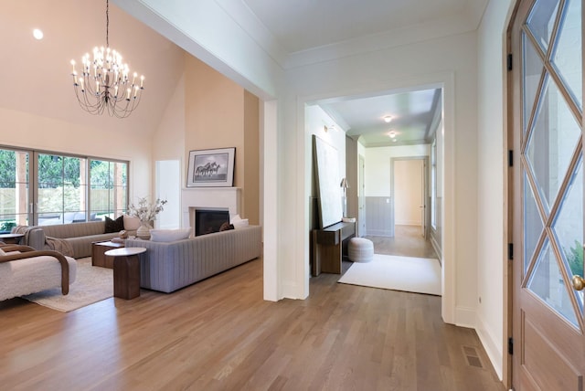 111 Keyway Dr, Nashville, TN 37205 - living area with a chandelier, light wood finished floors, ornamental molding, baseboards, and a fireplace