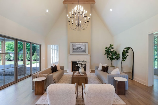 111 Keyway Dr, Nashville, TN 37205 - living room featuring high vaulted ceiling, light wood finished floors, a chandelier, a fireplace, and baseboards