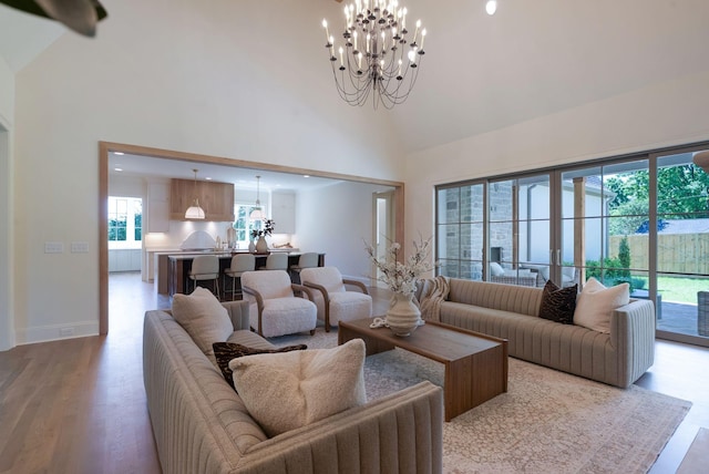 111 Keyway Dr, Nashville, TN 37205 - living room featuring a chandelier, high vaulted ceiling, healthy amount of natural light, and light wood-type flooring