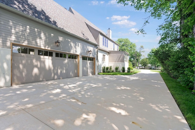 111 Keyway Dr, Nashville, TN 37205 - view of side of property with driveway, a chimney, and an attached garage
