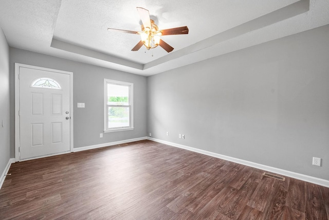 3404 Albert Dr, Clarksville, TN 37042 - entryway with visible vents, baseboards, ceiling fan, dark wood-style floors, and a tray ceiling