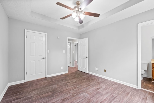 3404 Albert Dr, Clarksville, TN 37042 - unfurnished bedroom featuring baseboards, wood finished floors, and a raised ceiling