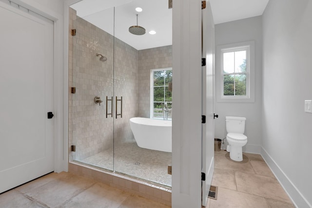 full bath with tile patterned flooring, plenty of natural light, a shower stall, and toilet