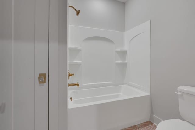 bathroom featuring washtub / shower combination and toilet