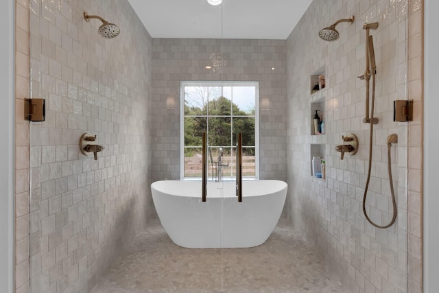 full bath with a soaking tub, tiled shower, and tile walls