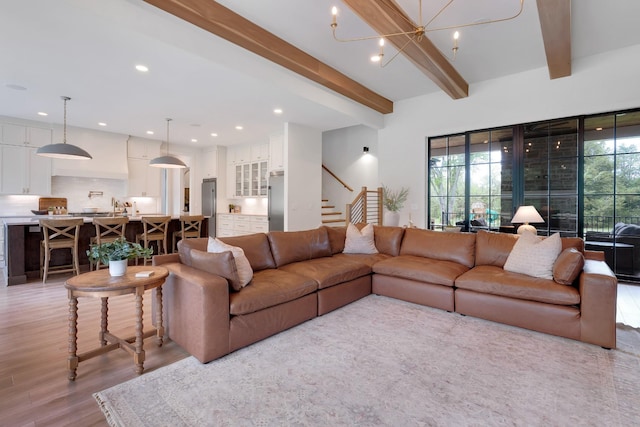 living room with recessed lighting, beamed ceiling, stairway, and light wood-style floors