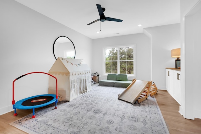 rec room with ceiling fan, recessed lighting, and wood finished floors