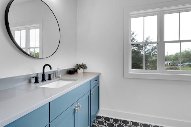 bathroom featuring baseboards, plenty of natural light, and vanity