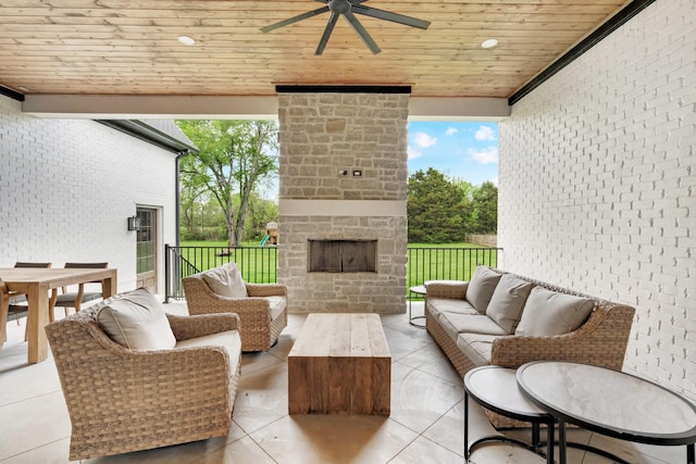 view of patio / terrace featuring a ceiling fan, an outdoor living space with a fireplace, and outdoor dining area
