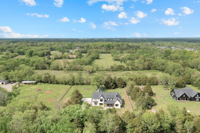 birds eye view of property with a view of trees and a rural view