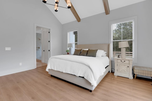 bedroom featuring baseboards, lofted ceiling with beams, light wood finished floors, and a notable chandelier