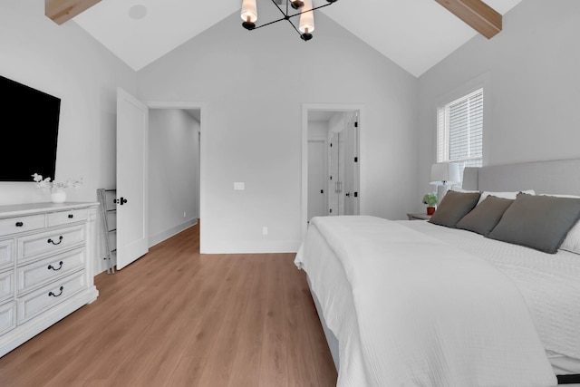 bedroom with an inviting chandelier, high vaulted ceiling, light wood-style flooring, and beam ceiling